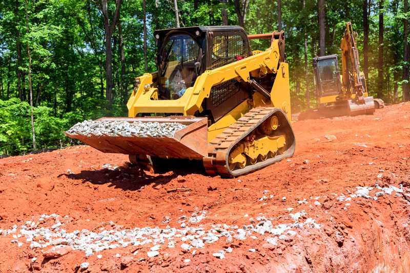 A Skidsteer and an excavator rental at a job site